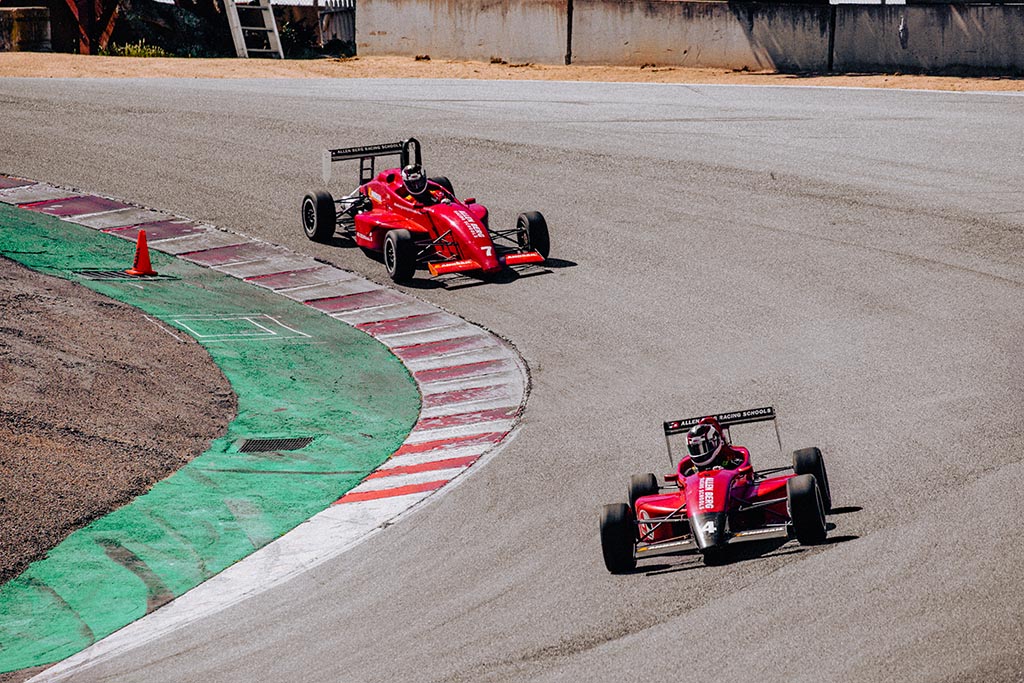 Red racing cars on curve track