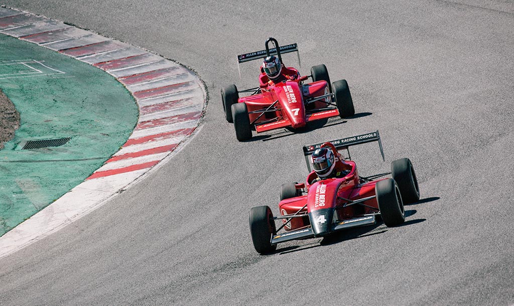 Red racing cars on track