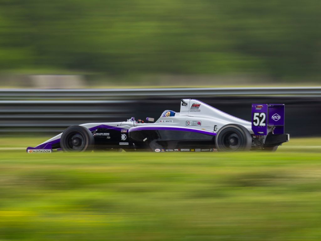 Berg racing car #52 in action during the race, showcasing high-speed performance on track.